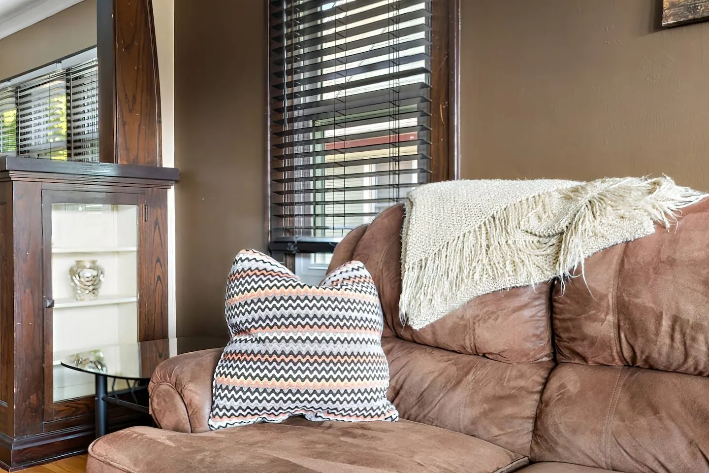 Sofa with a knit throw by the window